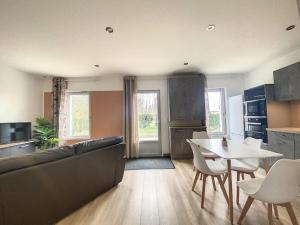 a living room with a couch and a table at Appartement 4 au calme dans le Sauternais in Budos +7 photos