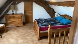a bedroom with a bed and a dresser at La Petite Breuille in Lainsecq