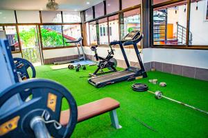 a gym with two exercise bikes and a treadmill at Nana Vientiane Hotel in Vientiane