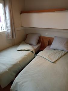 two beds sitting next to each other in a room at LA CASA in Biville-sur-Mer