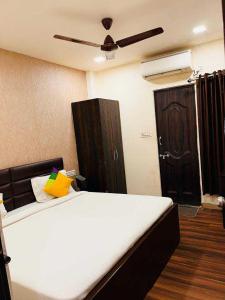 a bedroom with a bed with a ceiling fan at OYO Hotel Happy Homes in Bhopal