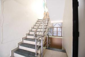 a metal staircase in a room with a window at OYO Hotel Happy Homes in Bhopal