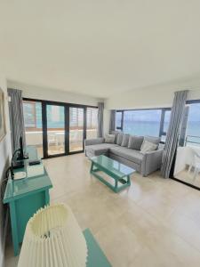 a living room with a couch and a table at Apartamentos Arrecife Playa in Arrecife