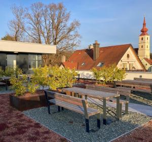 a group of benches sitting in front of a building at Reload by BestChoice - Parking - Self Check-in in Graz