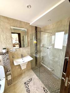 a bathroom with a sink and a shower at Luxury 3 Bedrooms Apartment Sea View in Rejiche
