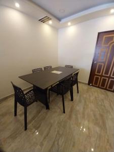 a conference room with a table and four chairs at Le Luminous, Home Stay in Port Blair