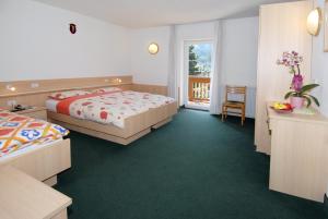 Postel nebo postele na pokoji v ubytování Hotel Zanon