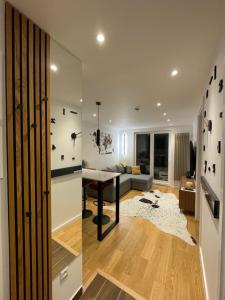 a living room with a table and a couch at Magi - Apartment with balcony in Jahorina