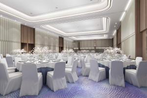 a banquet hall with white tables and white chairs at Lanson Place Mall of Asia Manila in Manila