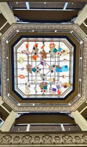 a ceiling in a building with a stained glass window at Heritage Luxury Suites All Suite Hotel in Lahore