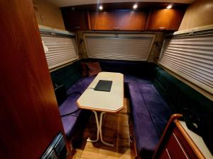 a small room with a table and a laptop on it at Que Camper Ct Full Bath in New Haven