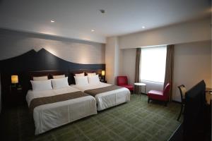 A bed or beds in a room at Hotel Bestland