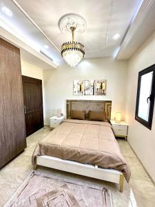 a bedroom with a large bed and a chandelier at Luxury Sea View 3 Bedrooms, Central AC, WiFi in Rejiche