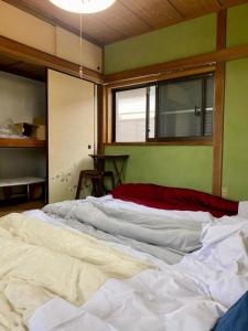 a large white bed in a room with a window at Shonan no Oka no Villa - Vacation STAY 24013v in Fujisawa