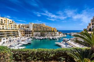 a marina in a city with boats in the water at Luxury Penthouse with Terrace and Views in St. Julianʼs