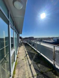 a balcony of a building with a view of a city at Nottingham City Centre Apartment in Nottingham