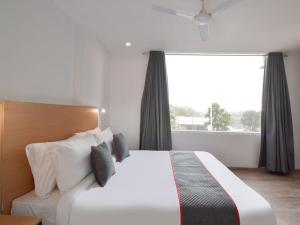 a bedroom with a large bed and a large window at Hotel Jaiman in Jaipur
