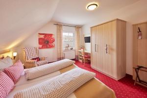 a living room with a couch and a chair in a room at Hotel Garni Dorfkammer in Olsberg