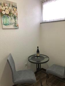 uma mesa com duas cadeiras e uma garrafa de vinho em Graciaa em Jajce