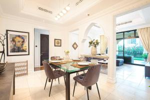 a dining room with a glass table and chairs at Tranquil Oasis- 2Bedroom, Connected to Dubai Mall in Dubai