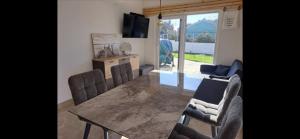 a living room with a dining room table and chairs at The House in Medulin