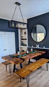 a dining room with a table and a mirror at *Hot* Fantastic 3/4 Beds Town House in Anfield Stadium in Liverpool