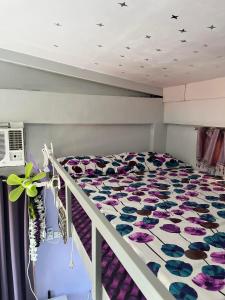 a bedroom with a bed with a colorful bedspread at JC Unit #8 in Urdaneta
