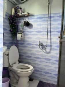 a bathroom with a toilet and a shower at JC Unit #8 in Urdaneta