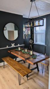 a dining room with a table and a mirror at *Hot* Fantastic 3/4 Beds Town House in Anfield Stadium in Liverpool