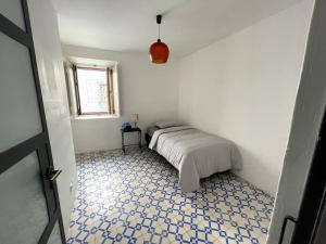 a bedroom with a bed with a blue and white floor at Puskin Suite in Sines