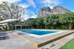 a swimming pool with a mountain in the background at Villa Bovalar in Polop