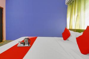 Habitación con cama de color rojo y azul en OYO S V Residency Kajaguda Near Gachibowli, en Hyderabad