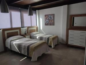 Postel nebo postele na pokoji v ubytování Apartamentos Séneca junto al Centro