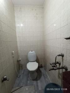a bathroom with a white toilet in a stall at Grand tower Chennai in Chennai