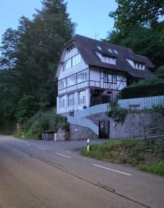 a large white house on the side of a road at Ferienwohnung Martina & Augusto in Baden-Baden