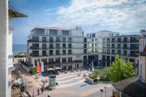 a large building with a plaza in front of the ocean at Villa Frohsinn App 15 in Bansin