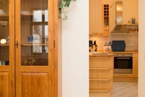 a kitchen with wooden cabinets and a counter top at Villa Frohsinn App 15 in Bansin