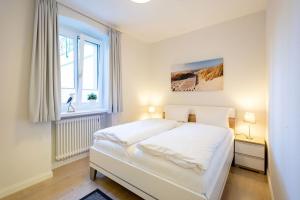 Postel nebo postele na pokoji v ubytování Villa Medici Heringsdorf App 01