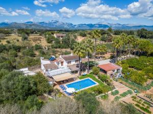 an aerial view of a home with a pool and palm trees at Ideal Property Mallorca - Can Tomeu in Llubí