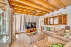 a living room with a couch and a tv at Ideal Property Mallorca - Can Tomeu in Llubí