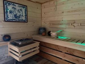 a sauna with wooden walls and wooden floors at Heidi Chalet in Rossinière