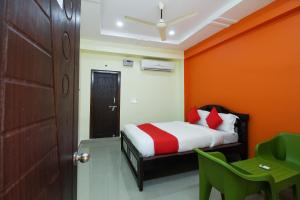 a bedroom with a bed and a door and a table at Flagship S V Residency in Lingampalli