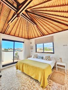 a bedroom with a large bed and a large window at No 23, Bali House in Lajares