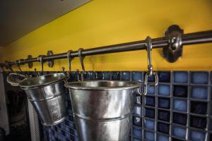 a pair of metal buckets hanging on a wall at Podskalí - zahradní apartmán in Teplice nad Metují