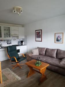 a living room with a couch and a coffee table at Niedersfeld Polzweg in Winterberg