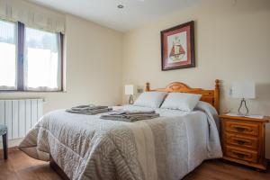 A bed or beds in a room at Apartamentos La Cortina