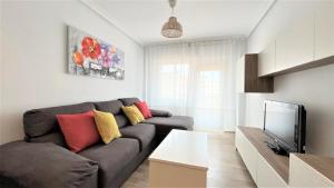 a living room with a couch and a tv at Palmar - 3 Habitaciones, cerca del Hospital Arrixaca in Murcia