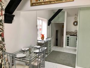 a dining room with a glass table and chairs at Charming 2-Bed Apartment in Waterloo Liverpool in Liverpool