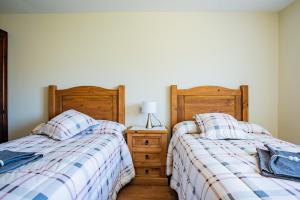 A bed or beds in a room at Apartamentos La Cortina