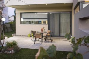 a patio with a table and chairs on it at Campagna Mare in Kissamos